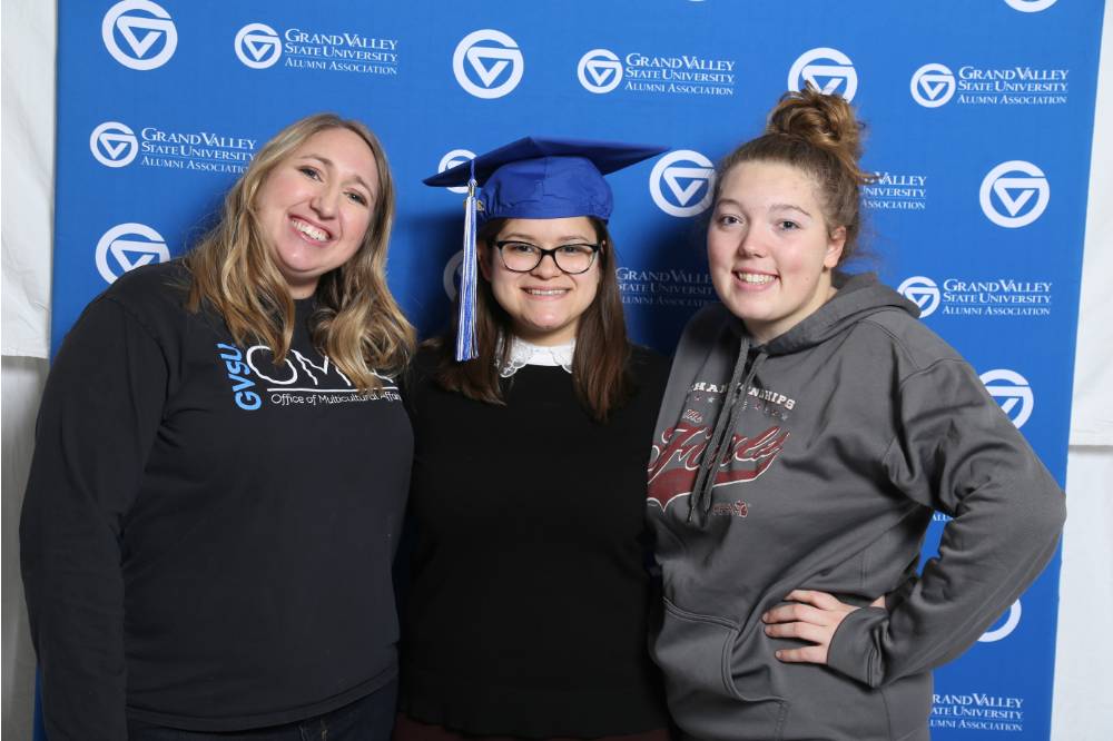 Three students pose together at GradFest
